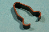 Special retainer for door sealing strip - snap fits into 1/4
